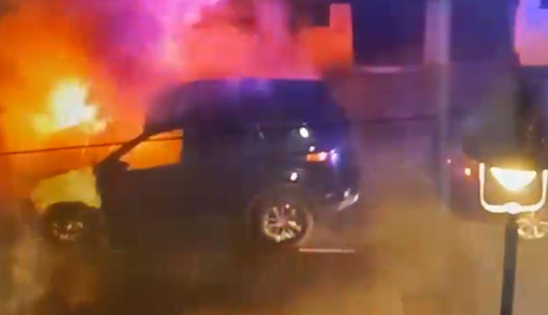 Screengrab from a video of firefighters tackling a burning car in a north London street.