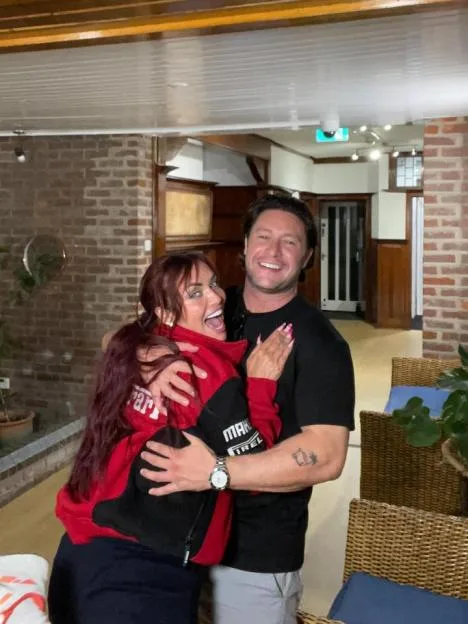 Tony Discipline and Shona McGarty hugging indoors.