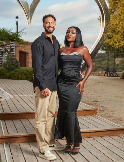 Lochan Nowack and Whitney Adebayo standing in front of a heart-shaped structure during the "Love Island" TV show final.
