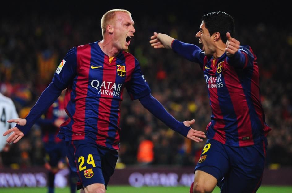 Jeremy Mathieu celebrates scoring a goal with Luis Suarez during a La Liga match.