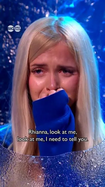 Rhianna Collins crying on Big Brother UK, covering her mouth with her blue sleeve with the subtitle "Rhianna, look at me, look at me, I need to tell you."