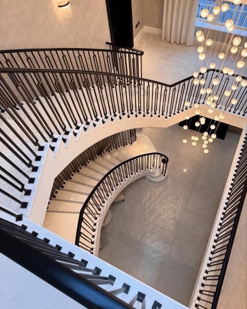 Grand spiraling staircase in Mark Wright and Michelle Keegan's home.