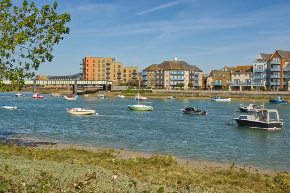 Waterfront housing and boats on the River Adur in Shoreham-by-Sea, England.