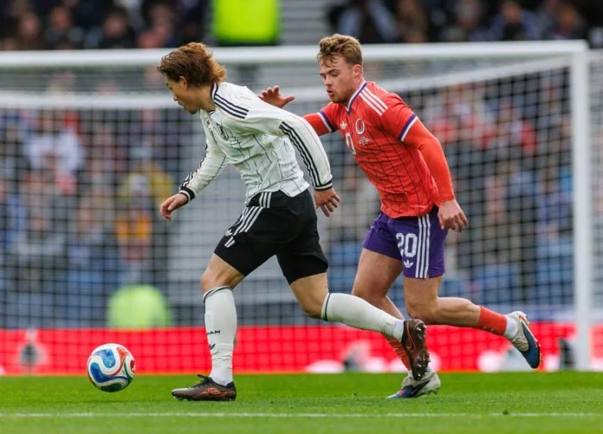Two soccer players competing for the ball during a match.