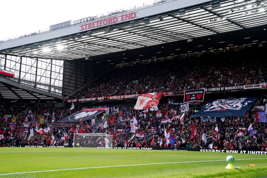 Manchester United fans with banners in support of Casemiro at Old Trafford.