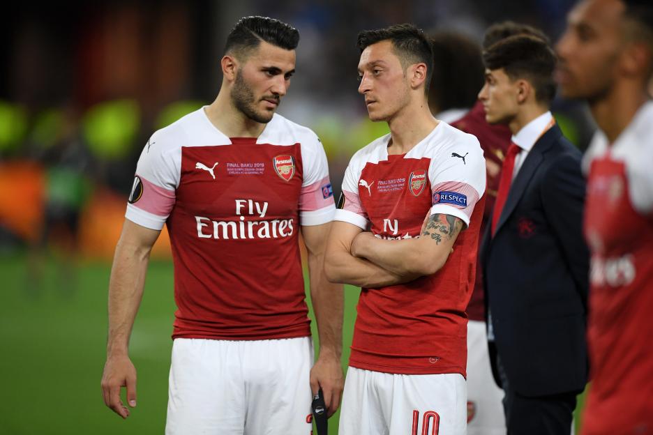Sead Kolasinac and Mesut Ozil of Arsenal looking dejected after a game.
