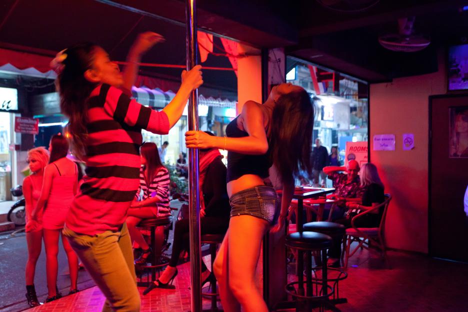young sexy thai girls performing pole dancing in pattaya gogo bar in walking street, pattaya, thailand