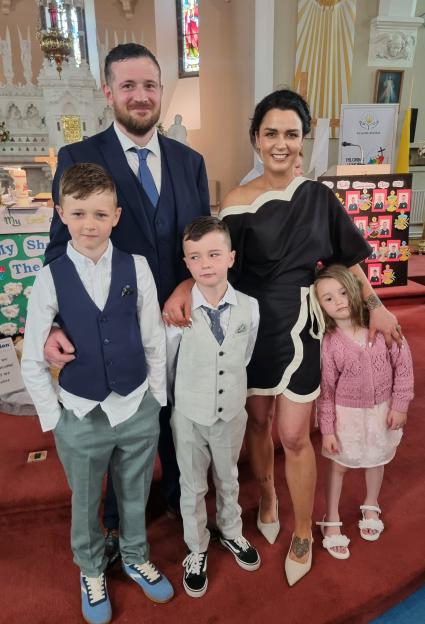 Family portrait inside a church with a man, a woman, and three children.