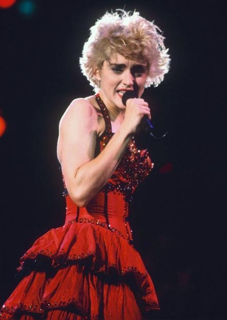 Madonna performing in a red corset at Wembley Stadium.
