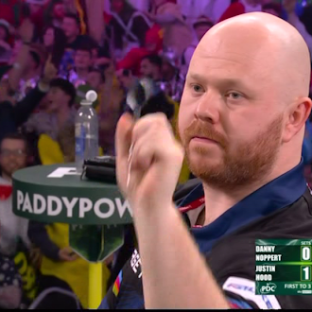 Danny Noppert competing in a darts match against Justin Hood.