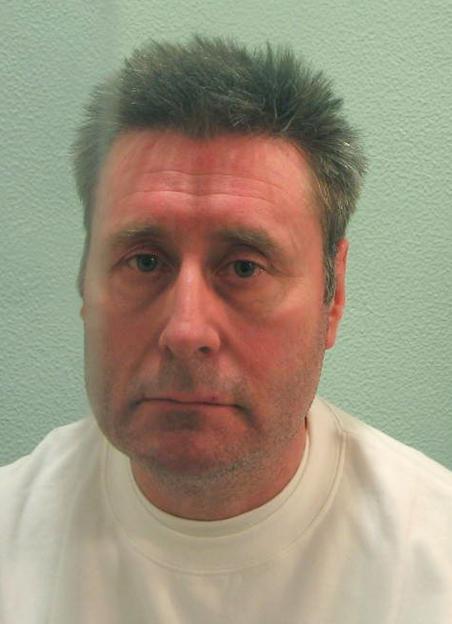 Mugshot of John Worboys, a man with short, graying hair and red-tinged skin, wearing a white crew-neck shirt.