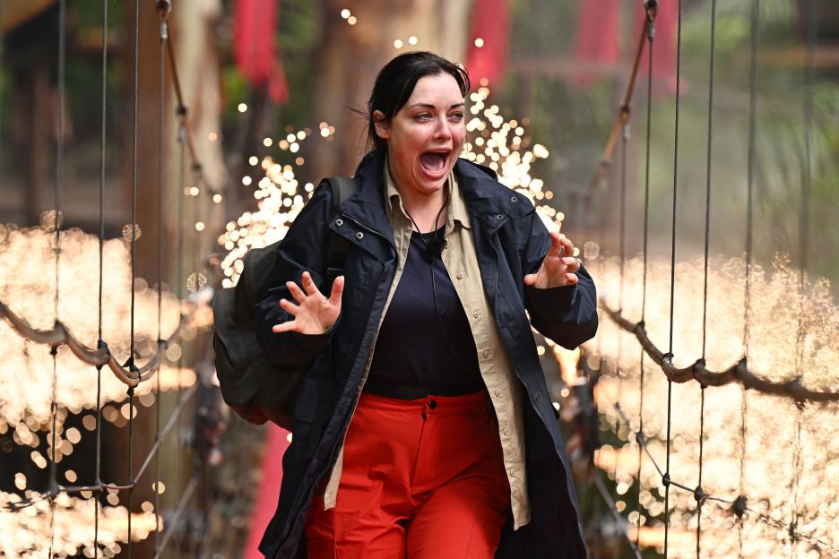 Shona McGarty reacting in shock with fireworks in the background during "I'm a Celebrity... Get Me Out of Here!"