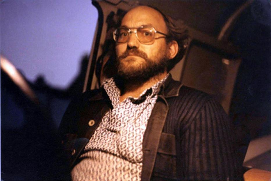 Mugshot of Robert Black, a man with a beard and glasses looking forward.