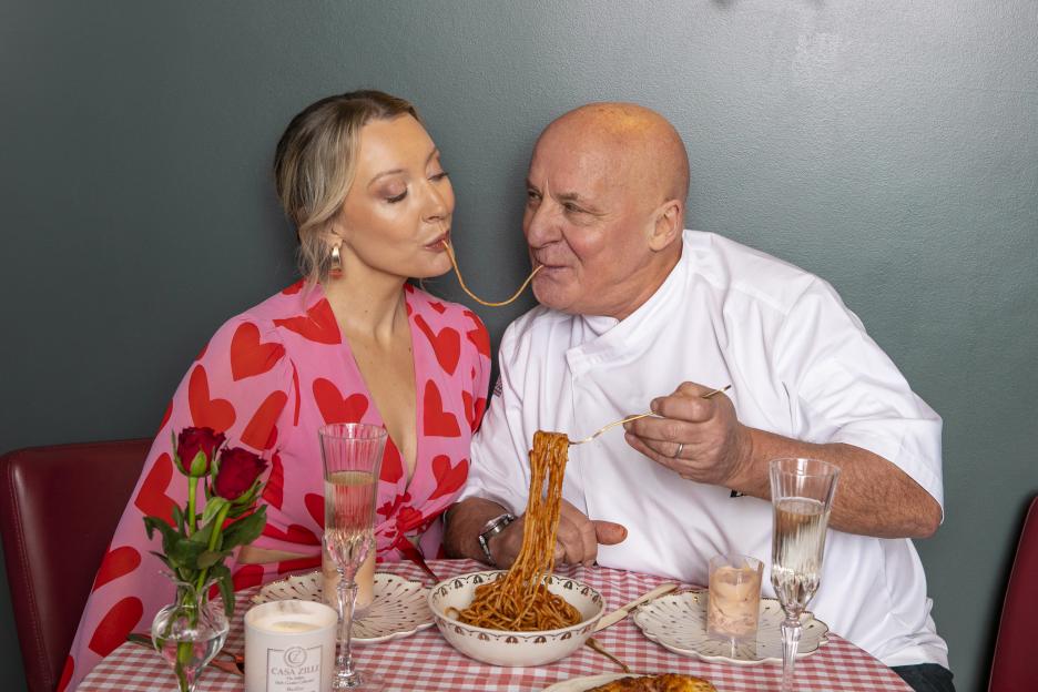 Aldo Zilli and Georgette Culley sharing spaghetti at a Valentine's Day dinner.
