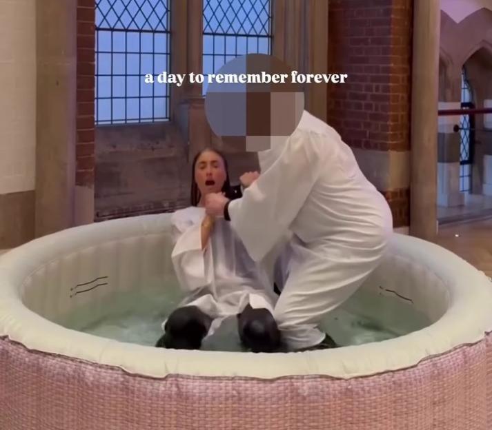 Lily Phillips getting baptized in a small pool.