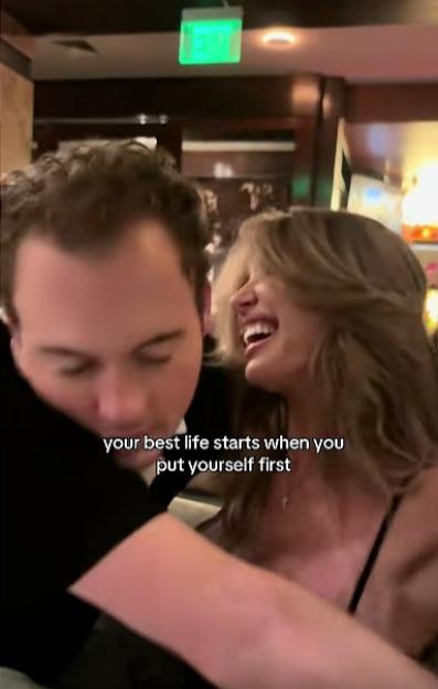 A man looking down while a woman laughs next to him, with text "your best life starts when you put yourself first" overlayed.