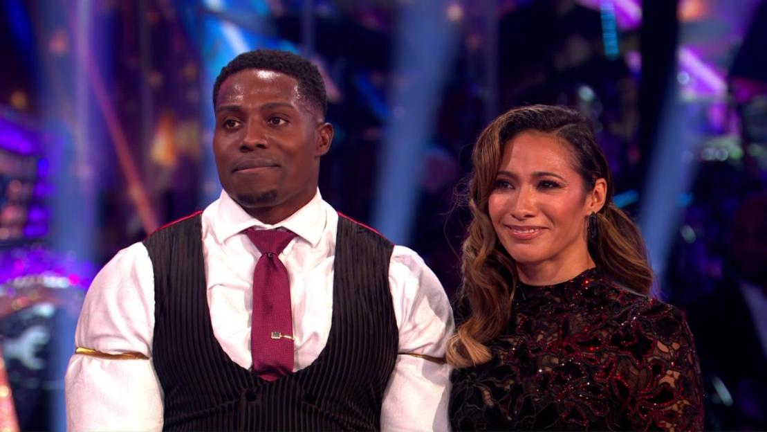 Male and female contestants from Strictly Come Dancing looking at results.
