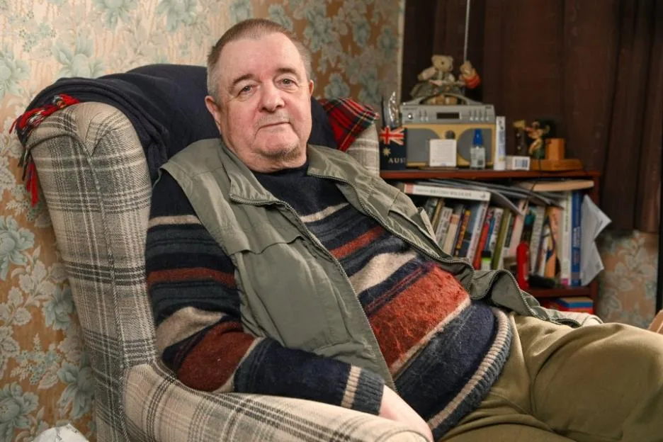 Tony Harris sitting in an armchair at his home.
