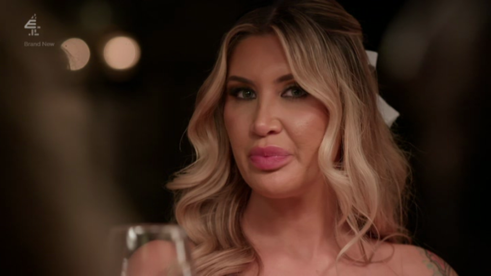 A woman with blonde hair and pink lipstick.