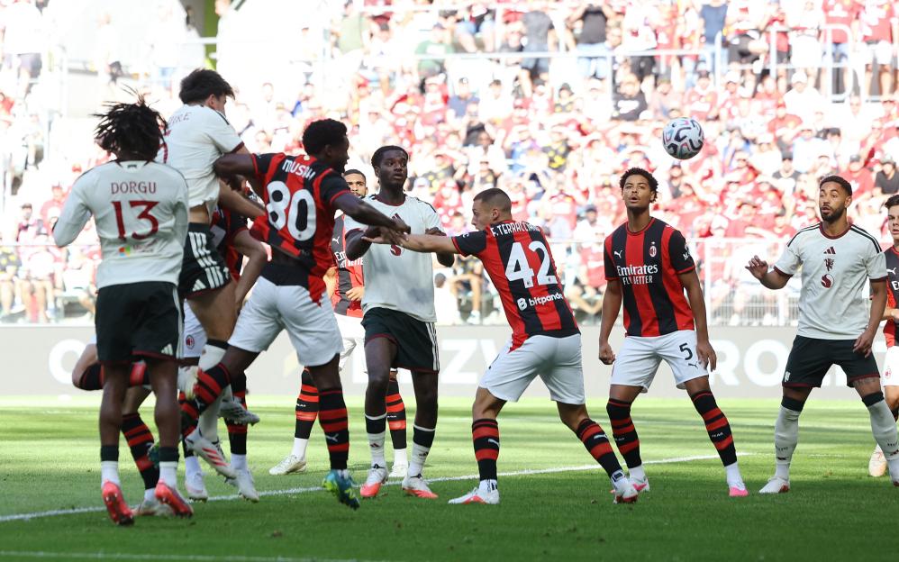 Manchester United's Harry Maguire scores the first goal against AC Milan.