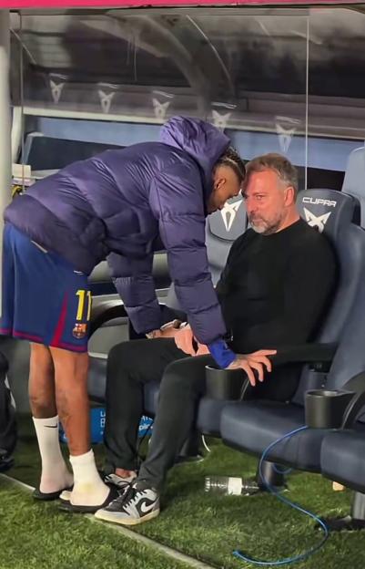 Raphinha consoles Hansi Flick after Barcelona's win.