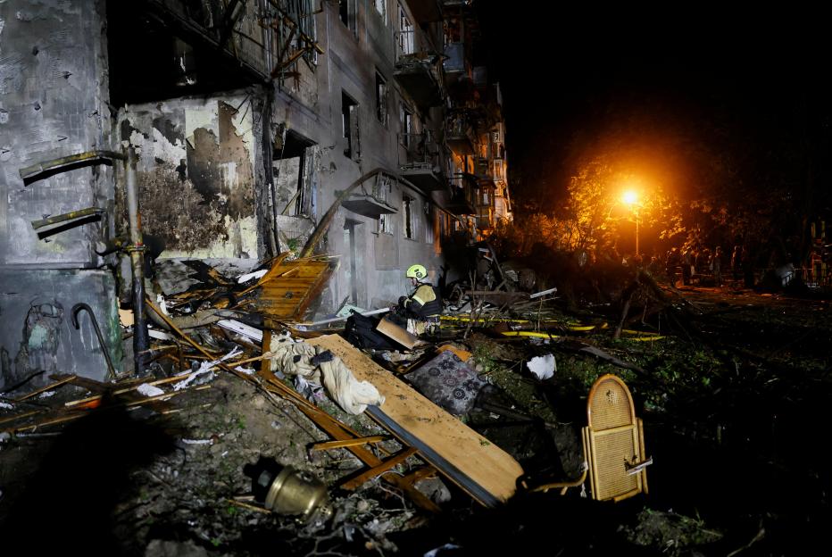 Firefighters work at the site of an apartment building hit by a Russian missile strike in Kyiv