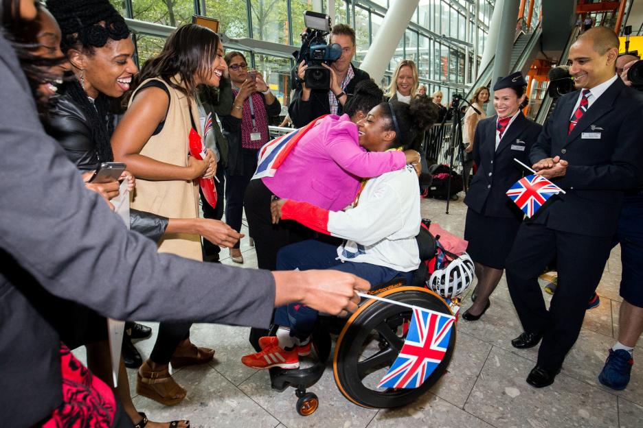 Kadeena Cox is greeted by family members upon her return from the Rio Paralympics at Heathrow Airport.