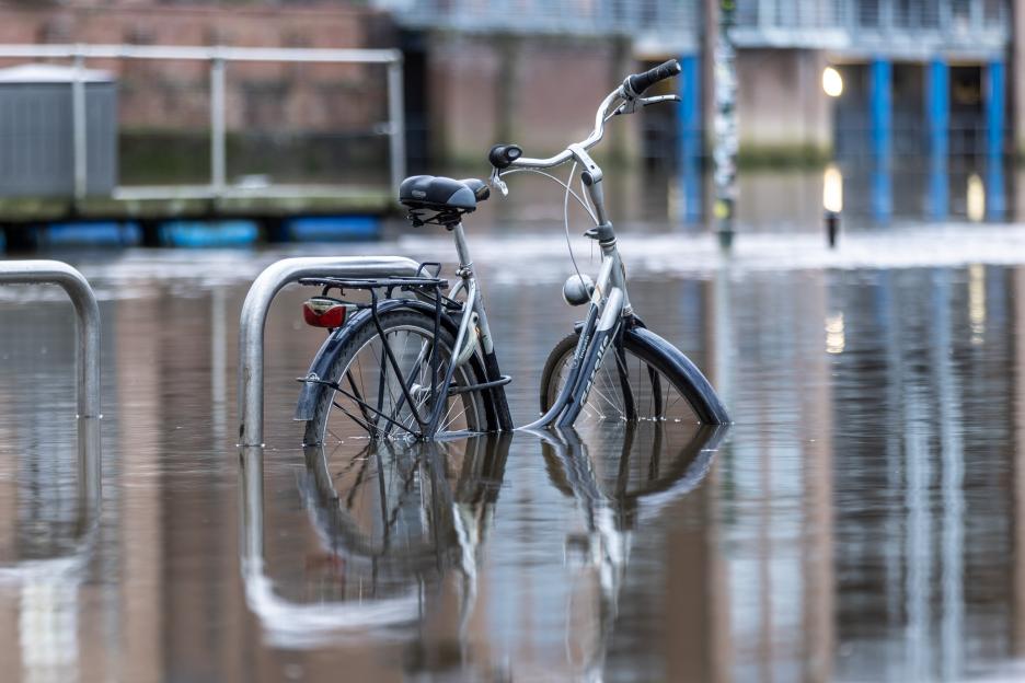 A bicycle partially submerged in floodwater in York, UK.