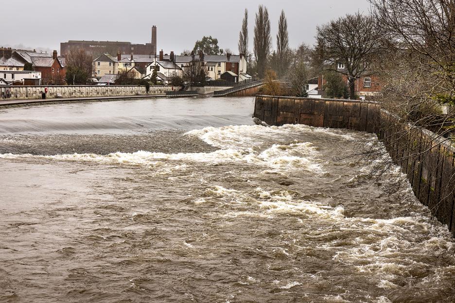 Police, fire, and ambulance personnel with their vehicles respond to an emergency incident at night.
