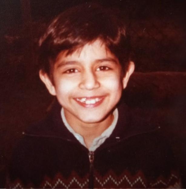 Portrait of a young boy named Vishal Mehrotra smiling at the camera.