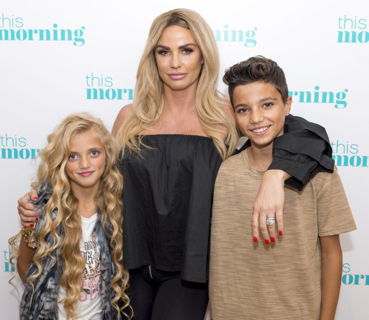 Katie Price, Princess Tiaamii, and Junior Andre posing in front of a "This Morning" backdrop.