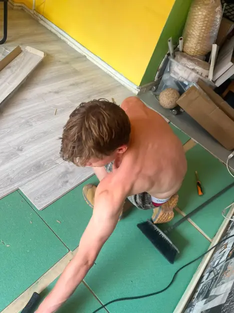A man installing new flooring.