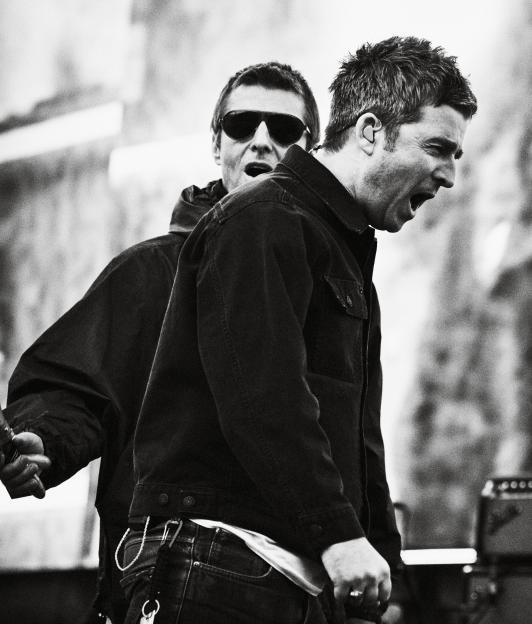Black and white collage of Noel Gallagher playing guitar and Liam Gallagher singing at the Oasis Live '25 Tour.