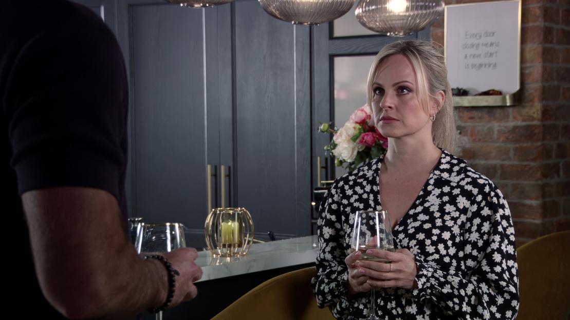 Sarah Barlow looks at Kit Green, who has just proposed to her, in a home setting.