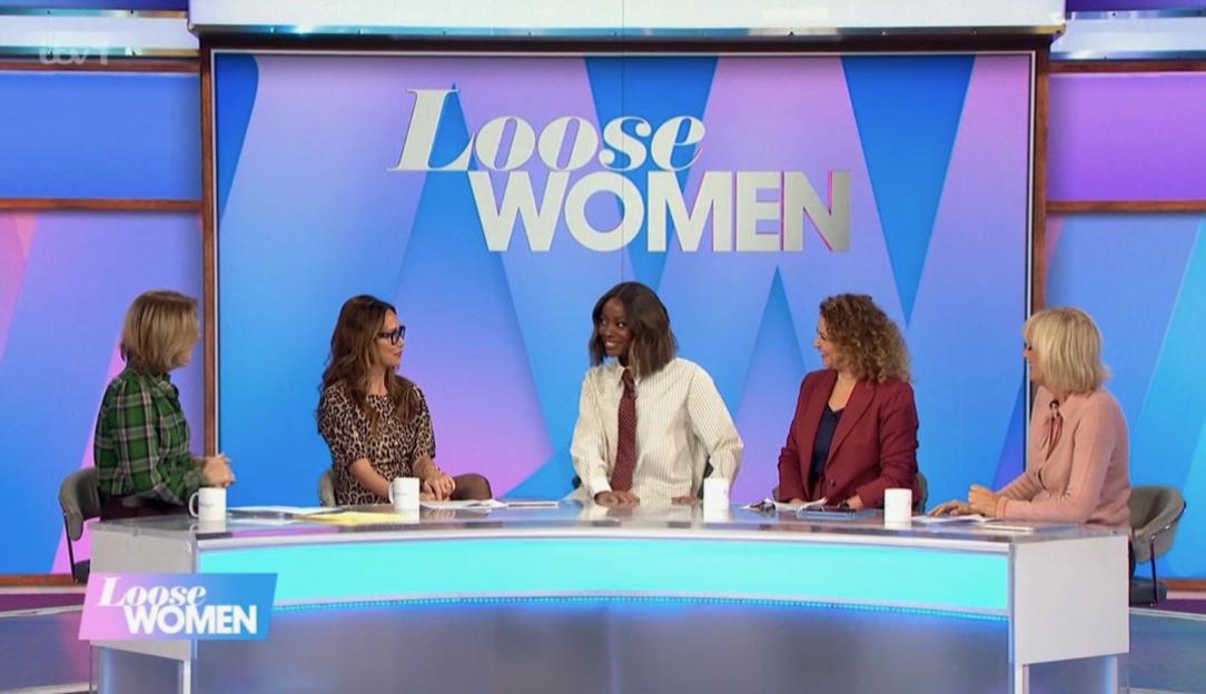Five women seated at a desk on the set of "Loose Women."