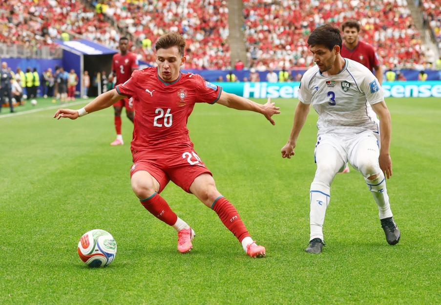 Portugal's Francisco Conceicao (26) and Uzbekistan's Khojiakbar Alijonov compete for the ball in the second half of a FIFA World Cup match at Houston Stadium in Houston, Texas, on Tuesday, June 23, 2026. Photo by Christian Brunskill/UPI