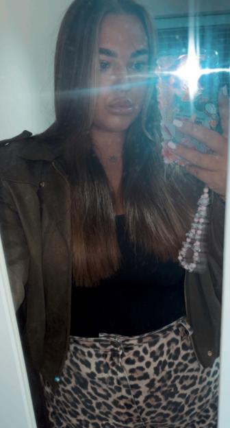Frankie Stone in a selfie wearing a dark jacket and leopard print pants.
