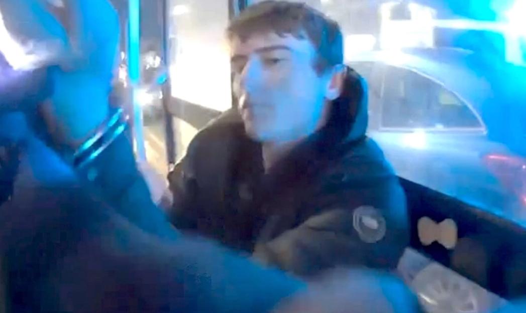 Logan Macphail, 17, in a police van after his arrest.
