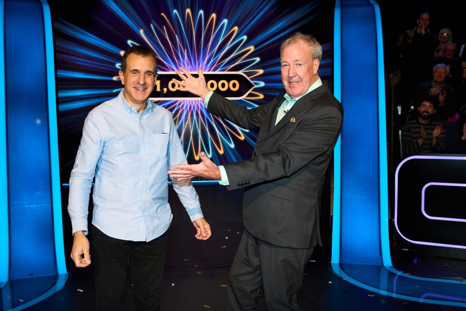 Roman Dubowski and Jeremy Clarkson standing on the Who Wants To Be A Millionaire set with a £1,000,000 graphic behind them.