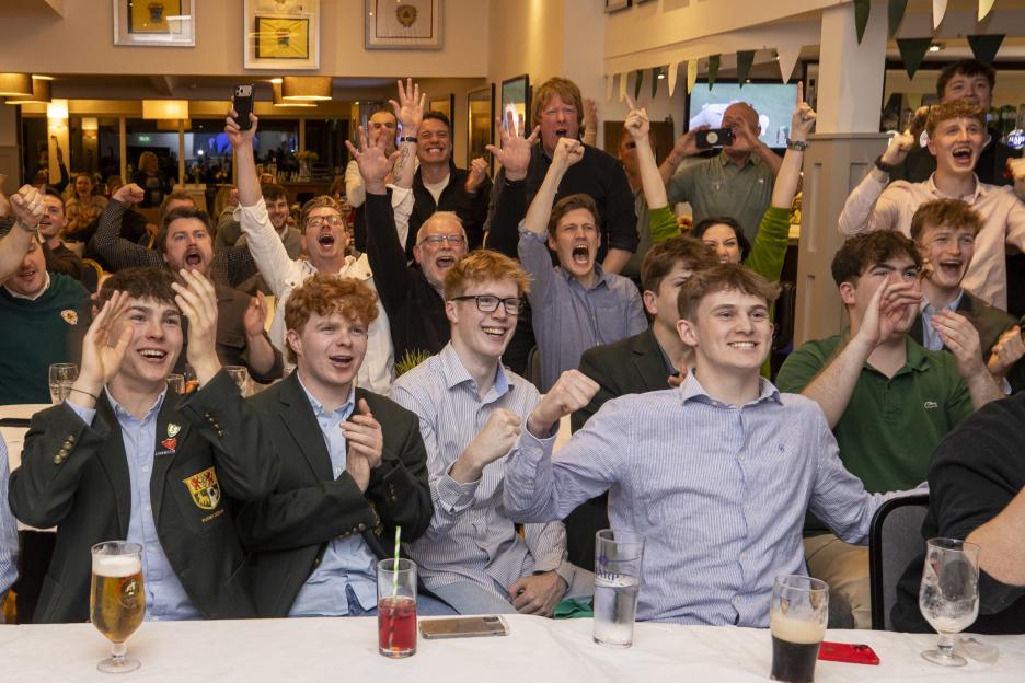 Members of the Holywood Golf Club reacting excitedly while watching the final day of the US Masters 2026.