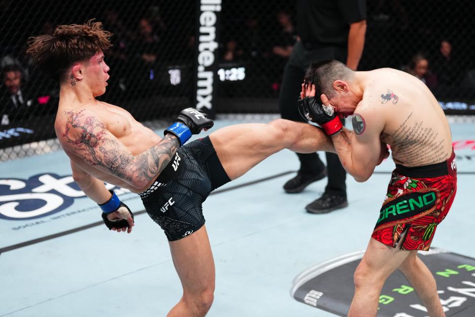 Lone'er Kavanagh of England kicks Brandon Moreno of Mexico in a flyweight fight during the UFC Fight Night.