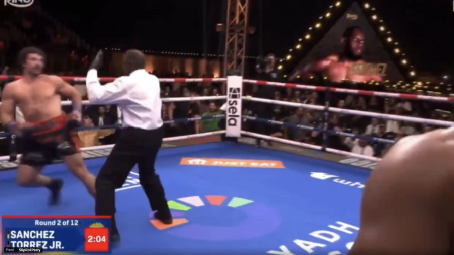 Boxing match between Sanchez and Torrez Jr., with a referee separating the two fighters in the ring.