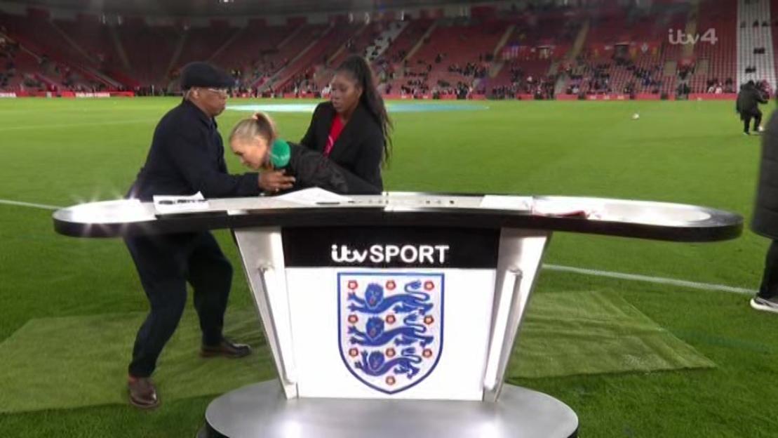 Laura Woods falling towards her co-presenters