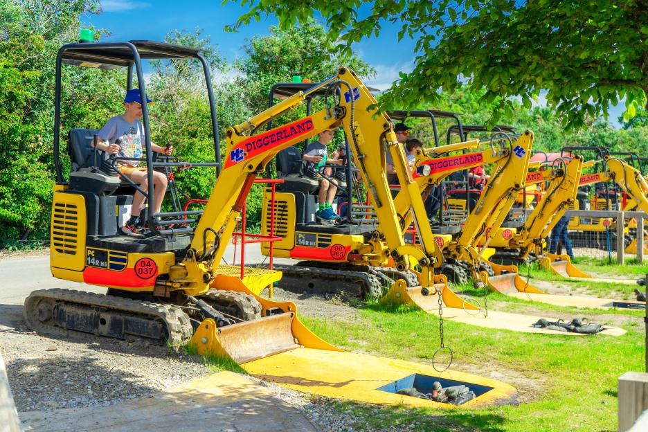 Children operating mini excavators at Diggerland.