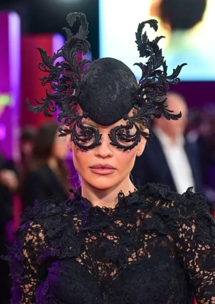 Rita Ora commands attention in gothic masquerade ensemble as she joins husband Taika Watiti on red carpet