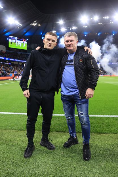 Former boxer Ricky Hatton and his son Campbell Hatton at a soccer stadium.