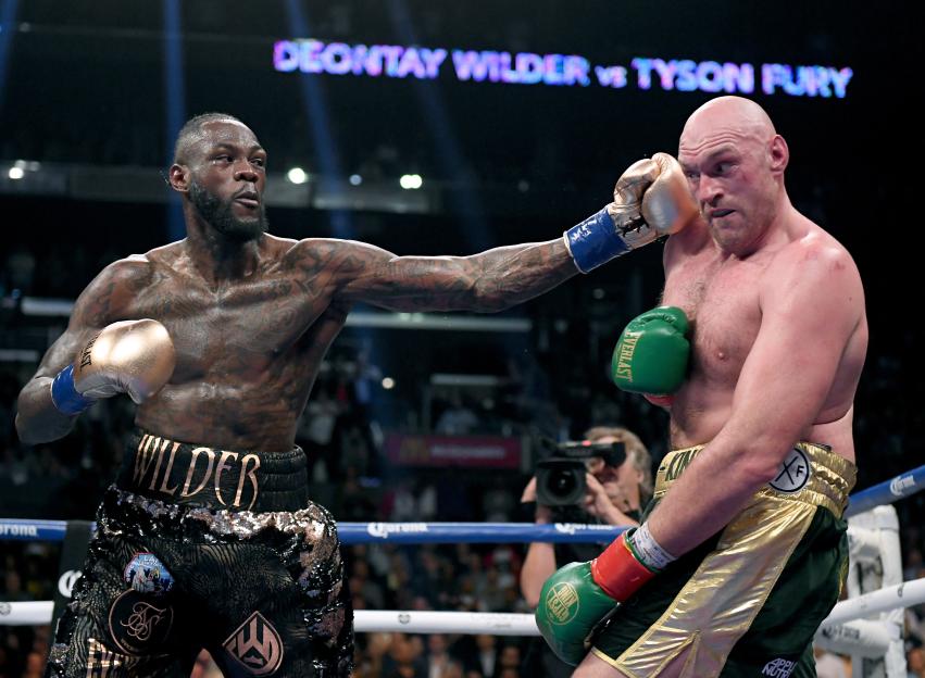 Deontay Wilder lands a punch on Tyson Fury during their heavyweight championship fight.
