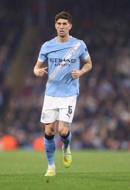 John Stones playing for Manchester City in a sky blue kit.