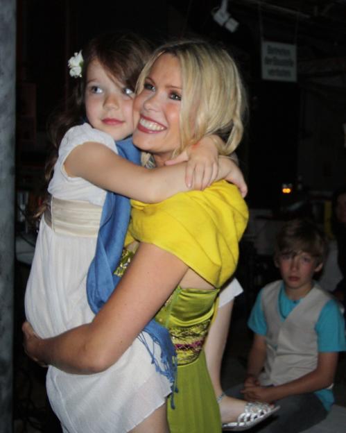 Melinda Messanger holding a young girl.