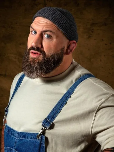 Joe Mahler, a contestant on the reality show The Celebrity Traitors, wearing a beanie and overalls.